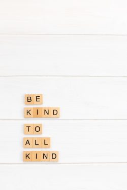 Scrabble tiles spelling the words be kind to all kind